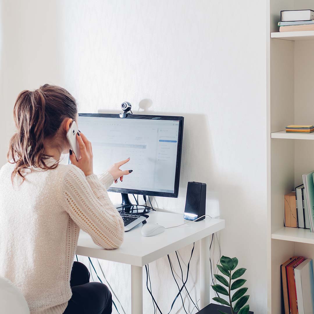 Woman working on a desk in a guest room